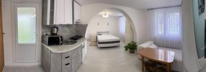 a kitchen with a sink and a bed in a room at House Menchul in Mala Uhol'ka