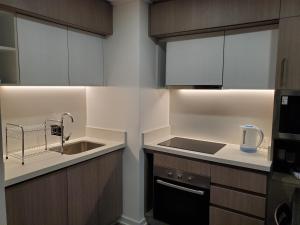 a kitchen with a sink and a stove top oven at Depto 2D/2B vista mar 6 personas in Concón +12 photos