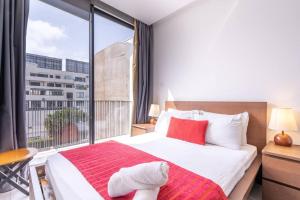 a bedroom with a large bed and a large window at New urban getaway 25 in Casablanca