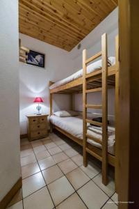 a bedroom with two bunk beds and a lamp at Joli Chalet Savoyard in Val-d'Isère