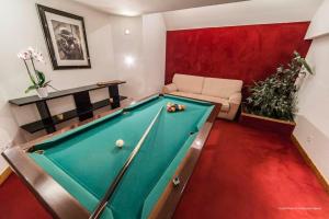 a living room with a pool table and a couch at Joli Chalet Savoyard in Val-d'Isère