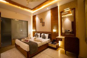 a bedroom with a bed with swans on it at Hotel RR 62 in Jaipur