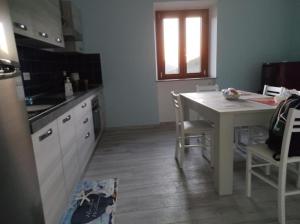 - une cuisine avec une table, une table et des chaises dans l'établissement La Dimora del Turano, à Castel di Tora