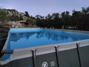 a large swimming pool with blue water at Agriturismo Munarin Caterina in Mioglia +8 photos