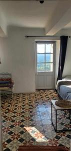 a bedroom with a bed and a window and a door at Maison avec vue panoramique in Trigance