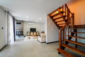 a living room with a spiral staircase and a living room at Vital Home Sapanca Isıtmalı Havuzlu Villa&Bungalov in Sapanca