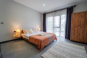 a bedroom with a bed and a large window at Vital Home Sapanca Isıtmalı Havuzlu Villa&Bungalov in Sapanca +66 photos