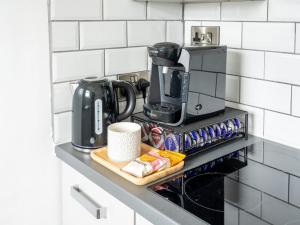 a kitchen counter with a coffeemaker and a coffee maker at Tettenhall Lodge Studio in Wolverhampton
