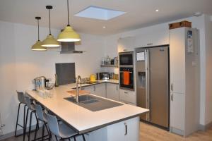 a kitchen with a sink and a counter top at Goodwood Events House with Garden & Parking - Chichester Holiday Properties in Chichester