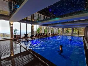 a man in a swimming pool in a building at Milmari L29 in Kopaonik