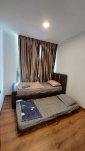 a bedroom with two beds and a window at Viva City Magamall Jazz 1 53 in Kuching