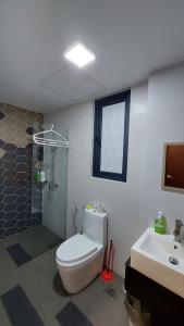 a bathroom with a toilet and a shower and a sink at Viva City Magamall Jazz 1 53 in Kuching