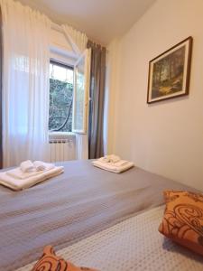 a bedroom with a bed with two towels on it at Casa Betti in Rapallo
