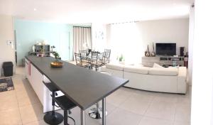 Il comprend une cuisine et un salon avec une table et un canapé. dans l'établissement Maison de 3 chambres a Valras Plage a 600 m de la plage avec spa jardin clos et wifi, à Valras-Plage