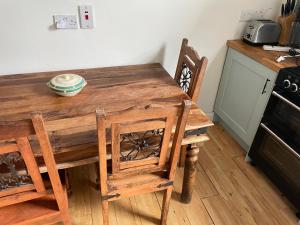 a wooden table and chairs in a kitchen at 123a Antrim Road in Belfast