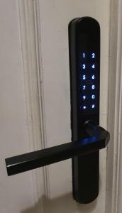 a black remote control attached to a door at Hostal Zamorán in Madrid