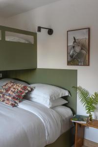 a bedroom with a bed and a picture of a horse at WITHIN THE VILLAGE in Galway