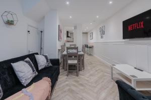 a living room with a couch and a table at Four Bed House At Primal Estates Short Lets in Brighton in Brighton & Hove
