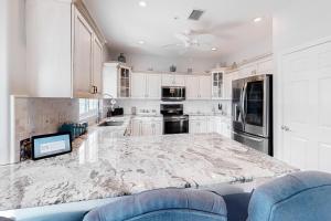 a white kitchen with a large marble counter top at Madeira Beach Manor in St. Pete Beach