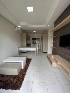 a living room with white furniture and a flat screen tv at Casa Maravilhosa em condominio in Luis Eduardo Magalhaes