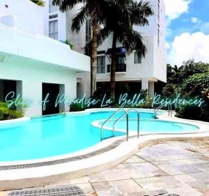 a swimming pool in front of a building at Slice of Paradise La Bella Residences in Tagaytay