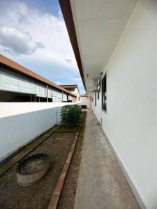 an empty hallway of a building with a plant at Ipoh stadium-18 pax (mahjong/5min to town) pets friendly in Ipoh