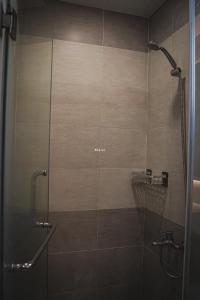 a bathroom with a shower with a glass door at Apartment Scenic Valley Quận 7 in Ho Chi Minh City
