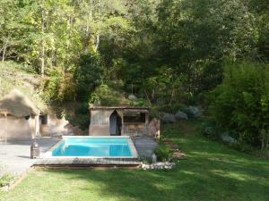 a swimming pool in a yard with a house at Gite unique et piscine privative dans un écrin de verdure in Culmont +19 photos