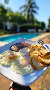 a plate of food with eggs and pretzels at Jaco Mizata Beach and River in La Libertad