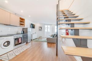 a kitchen and living room with a staircase in a house at Ajuda Deluxe Apartments in Lisbon