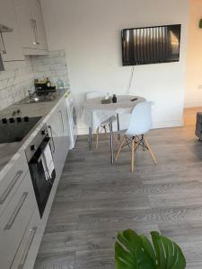 a kitchen with a table and a table and chairs at The Bricklane Artistic Studio in London