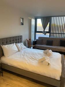 a bedroom with a bed with towels on it at The Bricklane Artistic Studio in London