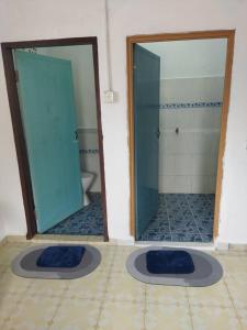 baño con 2 puertas de cristal y aseo en Ustazah Homestay, en Kampong Ru Sepuloh