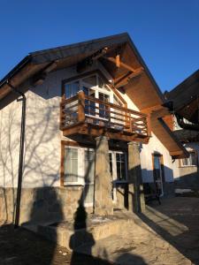 a house with a balcony on the side of it at Cottage Familiya in Verkhovyna