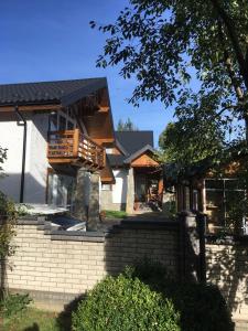 a house with a deck on the front of it at Cottage Familiya in Verkhovyna