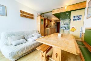 een woonkamer met een bank en een tafel bij L'ivresse des sommets #AH2 in Huez