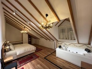 a bedroom with a bed and a bath tub at Chestnut Hill in Kolgecaj