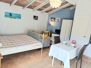 a bedroom with a bed and a table and a desk at La Casita in Manacor