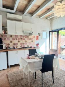 a kitchen with a white table and chairs in it at La Casita in Manacor