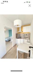 a kitchen with a white table in a room at Studio 30 m2 cocooning Timone Marseille in Marseille