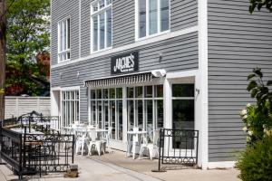 a cafe with tables and chairs outside of a building at Midtown Modern - urban condo walkable to bars and beach in Traverse City
