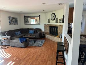 a living room with a couch and a fireplace at Coast, Mountain & Country in Simi Valley