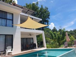 a villa with a swimming pool and a house at Sunset Villa - Stunning Poolside in Sámara