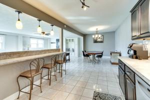a kitchen and dining room with a bar with stools at Updated Robinson Vacation Rental with Fireplace! in Robinson