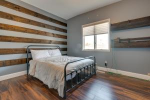 a bedroom with a wooden accent wall and a bed at Updated Robinson Vacation Rental with Fireplace! in Robinson