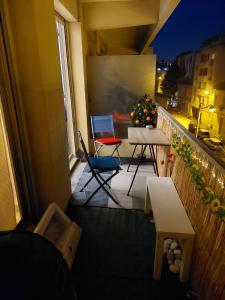 a balcony with a table and chairs on a building at Studio 30 m2 cocooning Timone Marseille in Marseille