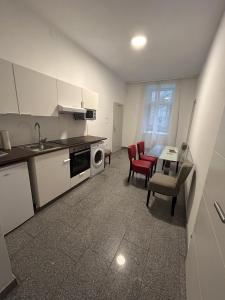 a kitchen and dining room with a table and chairs and a microwave at Cozy City Center Apartments in Vienna