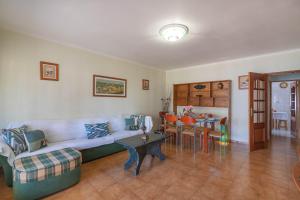 a living room with a couch and a table at Quarteira CONDESTÁVEL T3 in Quarteira