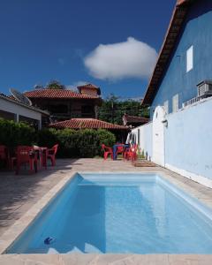 a swimming pool in the backyard of a house at Caiçaras Búzios in Búzios