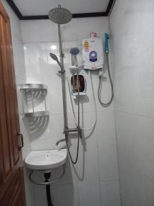 a bathroom with a shower and a sink at watthat & Maladress GUESTHOUSE in Luang Prabang